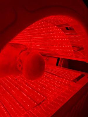A client in our red light therapy bed.