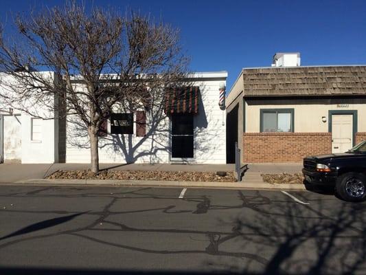 Barber shop is the white building.