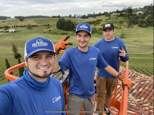 Tile roof cleaning team on 13,000 sq foot roof with 85 foot man lift