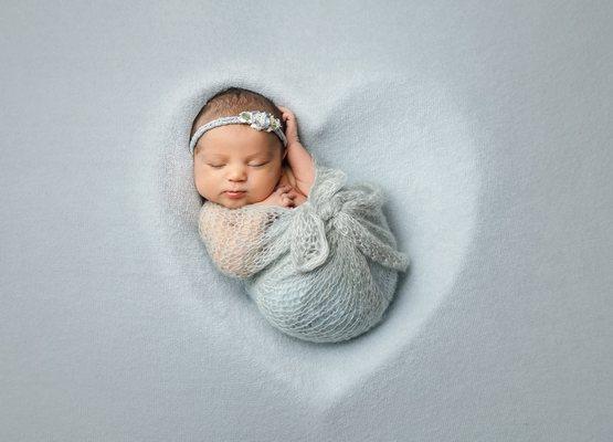 Newborn posed in heart, swaddled in soft mohair wrap at Austin Newborn Photography.