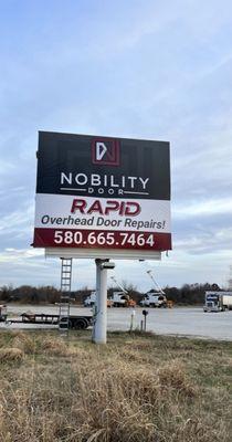 Nobility Door billboard on highway 3W