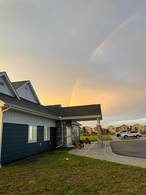 Front angle view of the new church facility, facing east, under a rainbow
