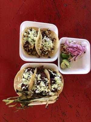 Chicken and pork tacos with charred onions.