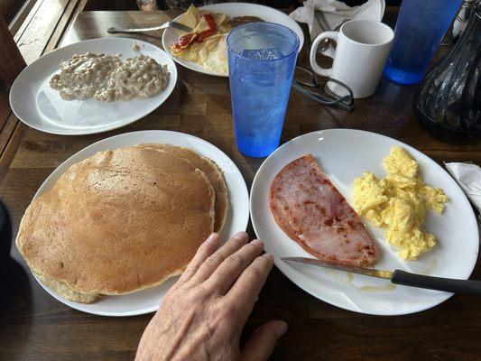 Pancakes, ham slice and scrambled eggs.