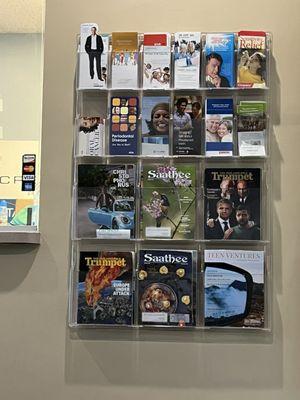 Magazine rack from Crescent Dental waiting room with Trumpet cult magazines displayed.