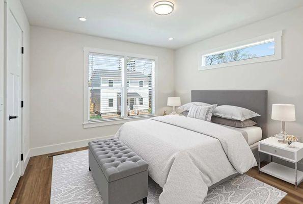 The bedroom at Belle Meadow Homes offers a bright and comfortable space for rest and relaxation.