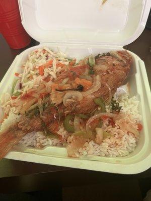 Fried red snapper over rice and veggies.