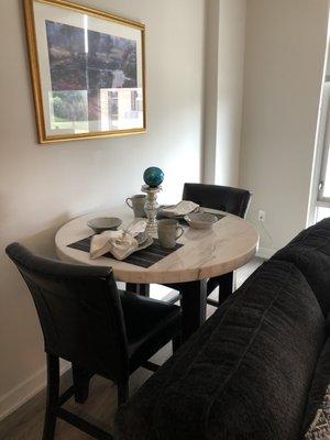 White marble round dining table with customize dish ware for two or four guest