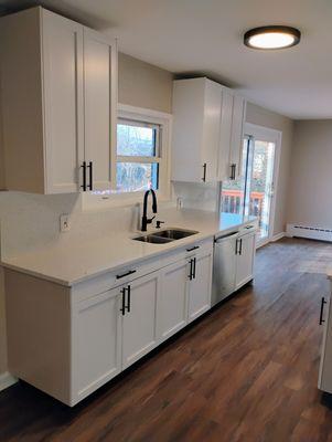 "Clean. Modern. Timeless. White shaker cabinets paired with sleek black hardware for a kitchen that shines."