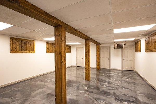 Basement remodel including a gorgeous epoxy floor & wood accents throughout.