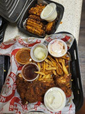 Chicken strips- hot with fries, slaw and dipping sauces. Lagniappe fried corn