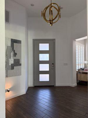 Entry way, door painted inside and exterior. It looks like new. The door had looked very rough and now it's smooth and beautiful.