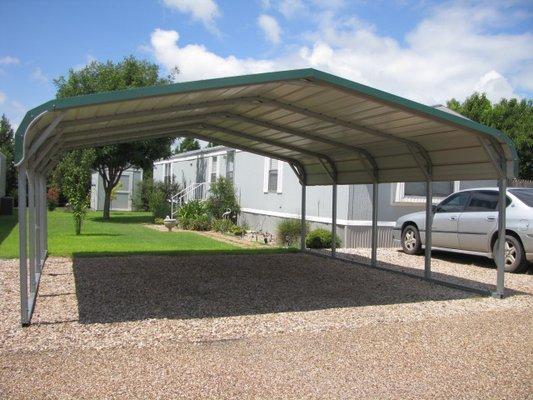 Mobile home space landscaped with carport and storage