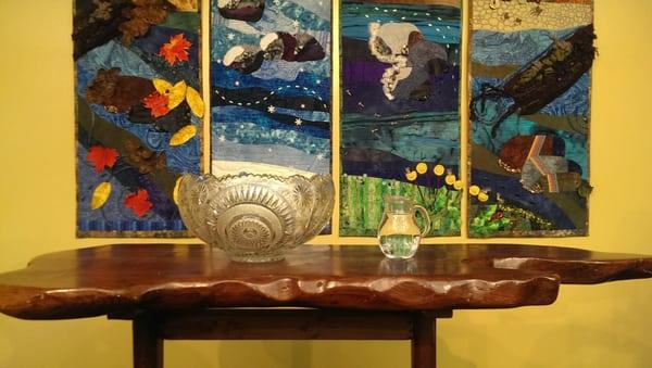 Preparations for the annual Water Communion, in front of the Four Seasons quilt (created by Lauren Furey) in the Sanctuary.