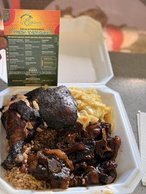 Oxtails, rice and peas, jerk, chicken, and cabbage