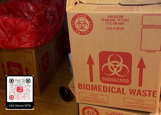 Two TCEQ Biomedical Waste boxes are stacked next to an open red-bag biohazard box.