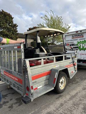 U-Haul truck and trailer, towing a golf cart