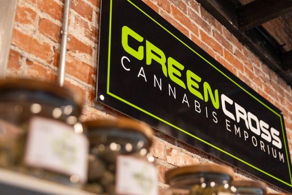 Close-up of Green Cross signage at Center St.