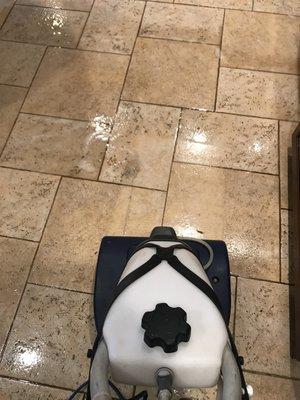 Heavy tile scrubbing before rinse and extraction.