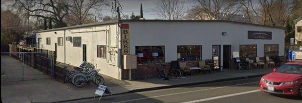 The bike shop is next door to the Antique store