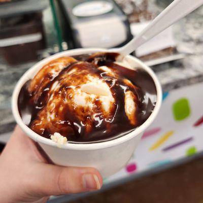 Strawberry ice cream with hot fudge.