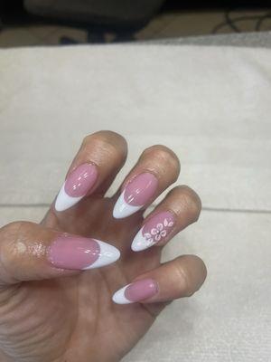 French tip almond shaped nails with flowers and gems
