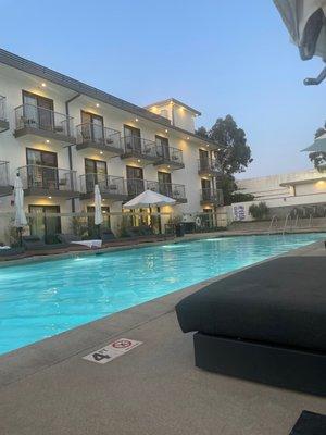 Pool area has a jacuzzi on the side as well