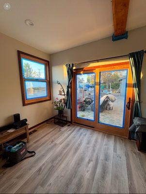 Before photo 1 of my livingroom with unfinished weight bearing beam, windows, doors, and trim.
