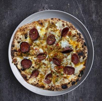Pepe Pizza Garlic-Cream, Mozzarella, Chili-Soaked Brussels, Soppressata. Finished with Smoked Honey, Chili Oil, Crushed Pistachio