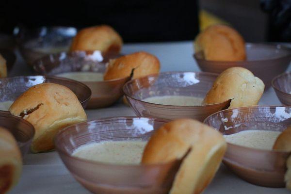 Broccoli cheese soup with dinner roll.