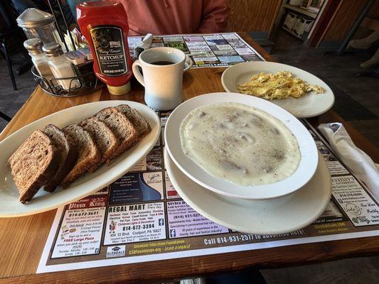 Sausage and gravy, two scrambled eggs and rye toast.