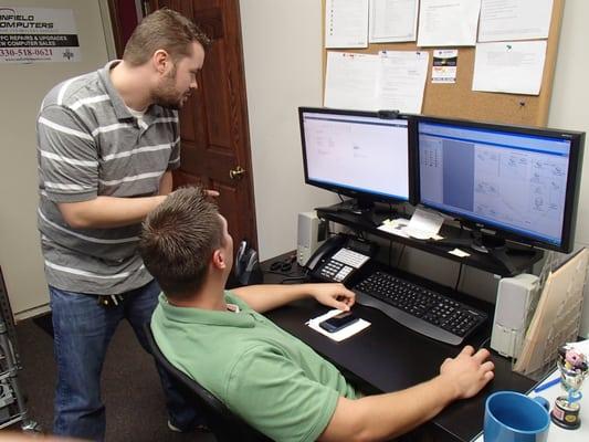 Helpdesk technicians troubleshooting a client's problem.