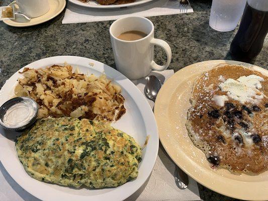 Greek omelette, side of tzatziki, home fries and blueberry pancakes with real butter.