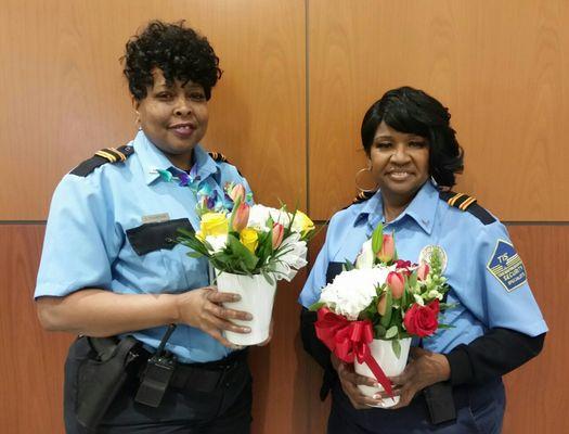 TIS Officers with flowers from a thankful client.