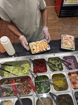 The food assembly line and my entree (chicken over rice platter)