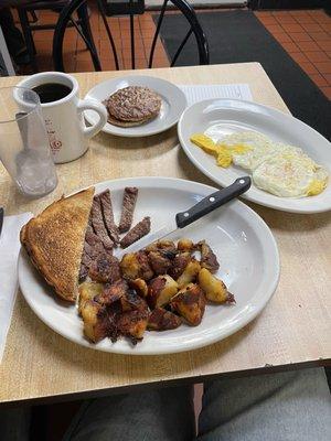 Steak, home fries, eggs, coffee & sausage patties