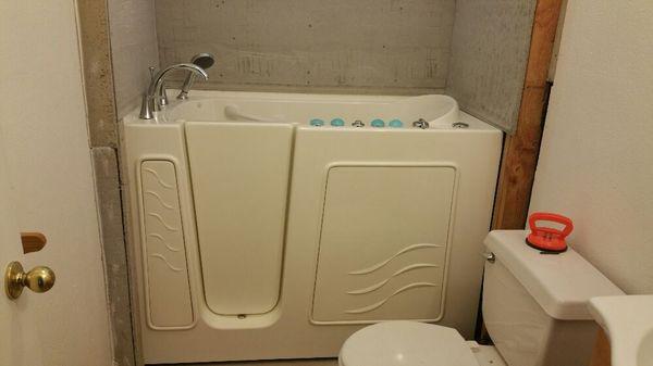 Walk in tub, 40 gallon electric gets tub 1/2 full. Shower with plastic chair would be money better spent.