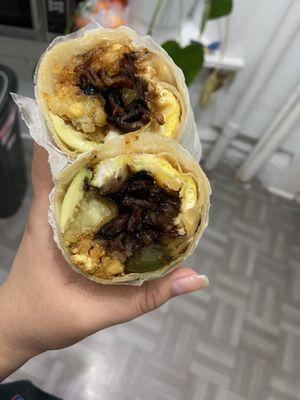 Breakfast burrito with eggs, bacon, avocado, peppers/onions and tater tots