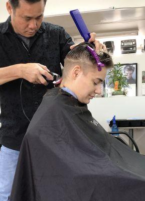 Our Barber cutting with precision