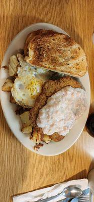 Country fried steak, rye toast, home fries, eggs over easy