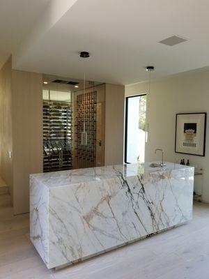 This is a bar cladded with book-matched slabs all around. The client wanted slabs that will enhance the entertainment bar & we helped him!