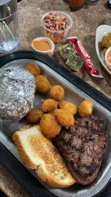 Sirloin with a loaded baked potato and scallops