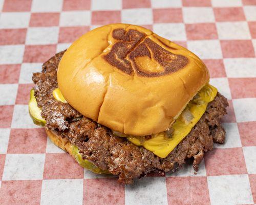 Double patty, 100% fresh beef burger served with American cheese, grilled onions, pickles and house sauce on a Martin's potat...