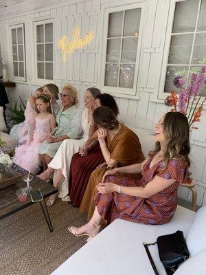 Great comfortable benches in front of the main house with the "relax" neon sign