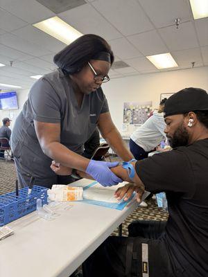 Terrance having his blood drawn from nickname basement vein or scientific name basilic vein. We learned this during our visit