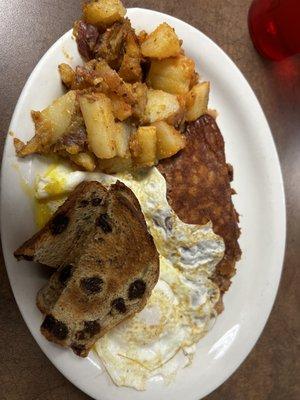 2 eggs over medium, hash, cinnamon raisin toast, and home fries