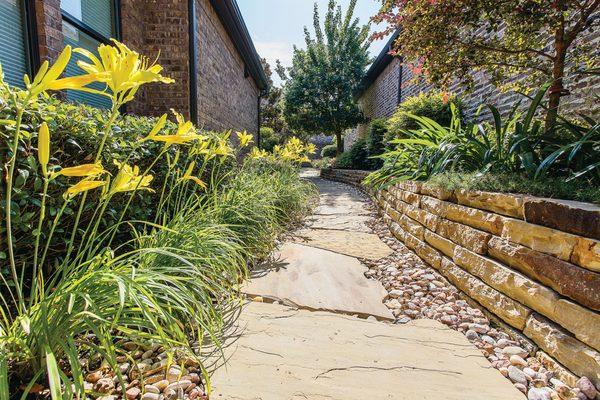 Dry Stacked Wall and Flagstone Walk in River Rock surrounded by beautiful landscaping
