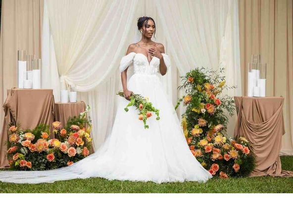 Elegant ceremony design with soft draping and intentional floral styling.