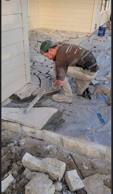 Owner Adam Paquette of Landscape and irrigation masters personally installing a Mexican cream flagstone patio