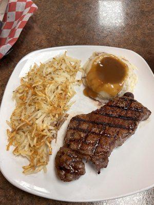 Blackened 10 oz ribeye with mashed potatoes and shredded hash browns